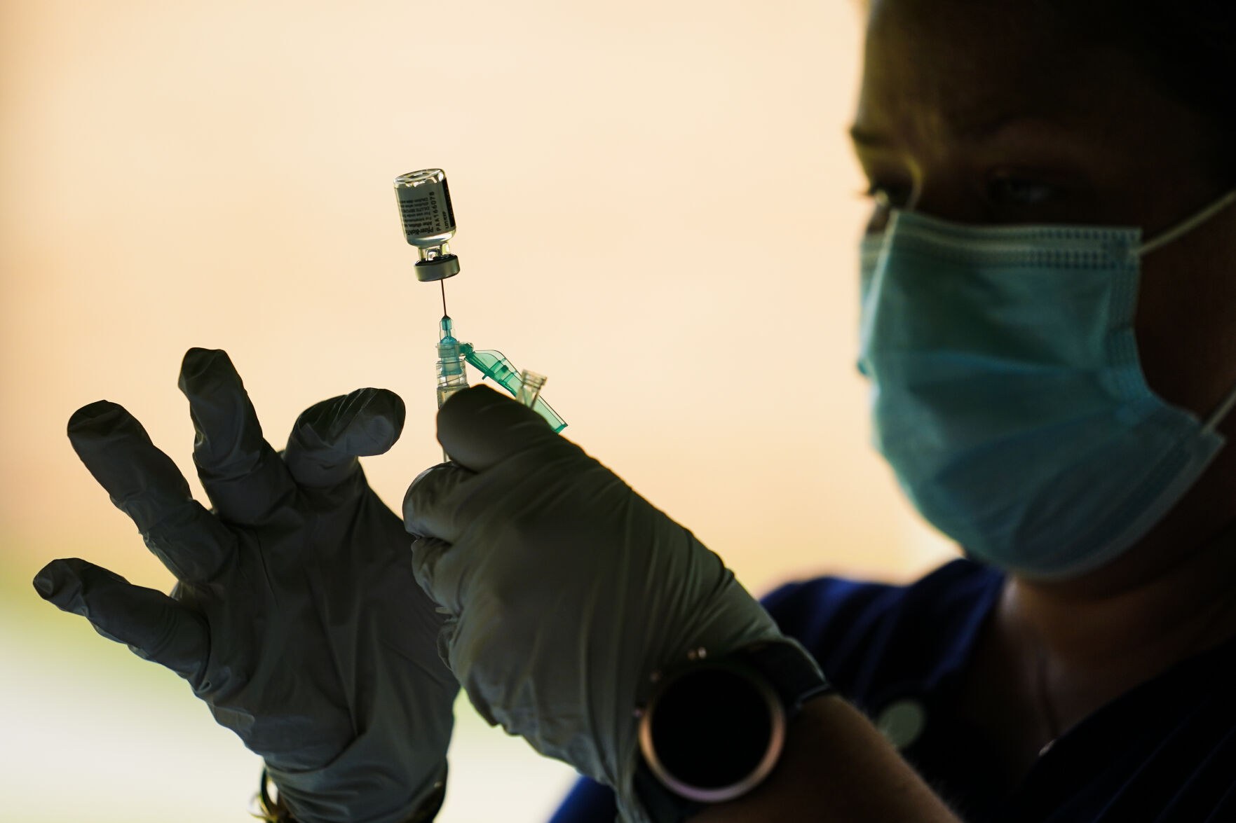 <p>In this Sept. 14, 2021 file photo, a syringe is prepared with the Pfizer COVID-19 vaccine at a clinic at the Reading Area Community College in Reading, Pa.</p>