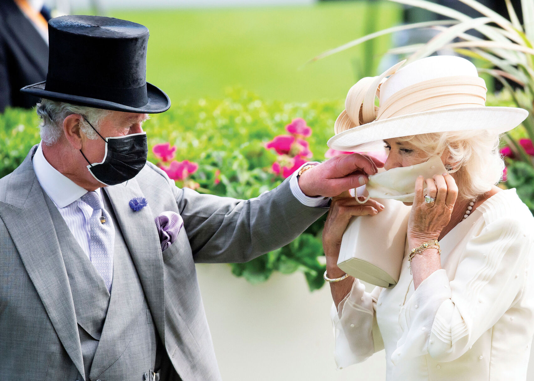 <p>The photo chosen by Charles and Camilla for their Christmas card went for a sign of the times, with an image of themselves wearing face masks.</p>