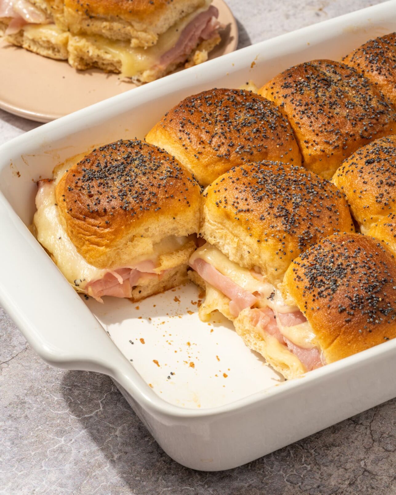 <p>These sliders have it all: sweet slices of ham, gooey Swiss cheese, squishy Hawaiian rolls, and a savory butter drizzle.</p>