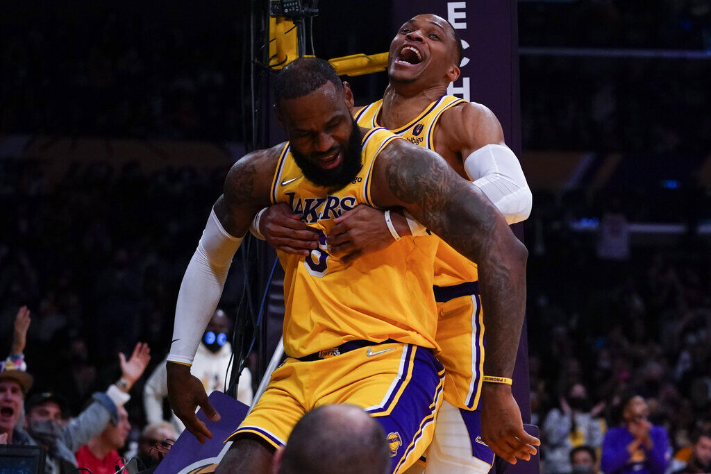 <p>Los Angeles Lakers forward LeBron James (6) is helped off the floor by guard Russell Westbrook, right, during the first half of an NBA basketball game against the Indiana Pacers in Los Angeles, Wednesday, Jan. 19, 2022. (AP Photo/Ashley Landis)</p>