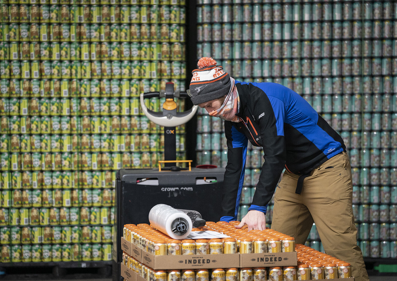 <p>Packing manager Erik Raivo packages up beer for distribution at Indeed Brewing Company on Feb. 18, 2022, in Minneapolis.</p>