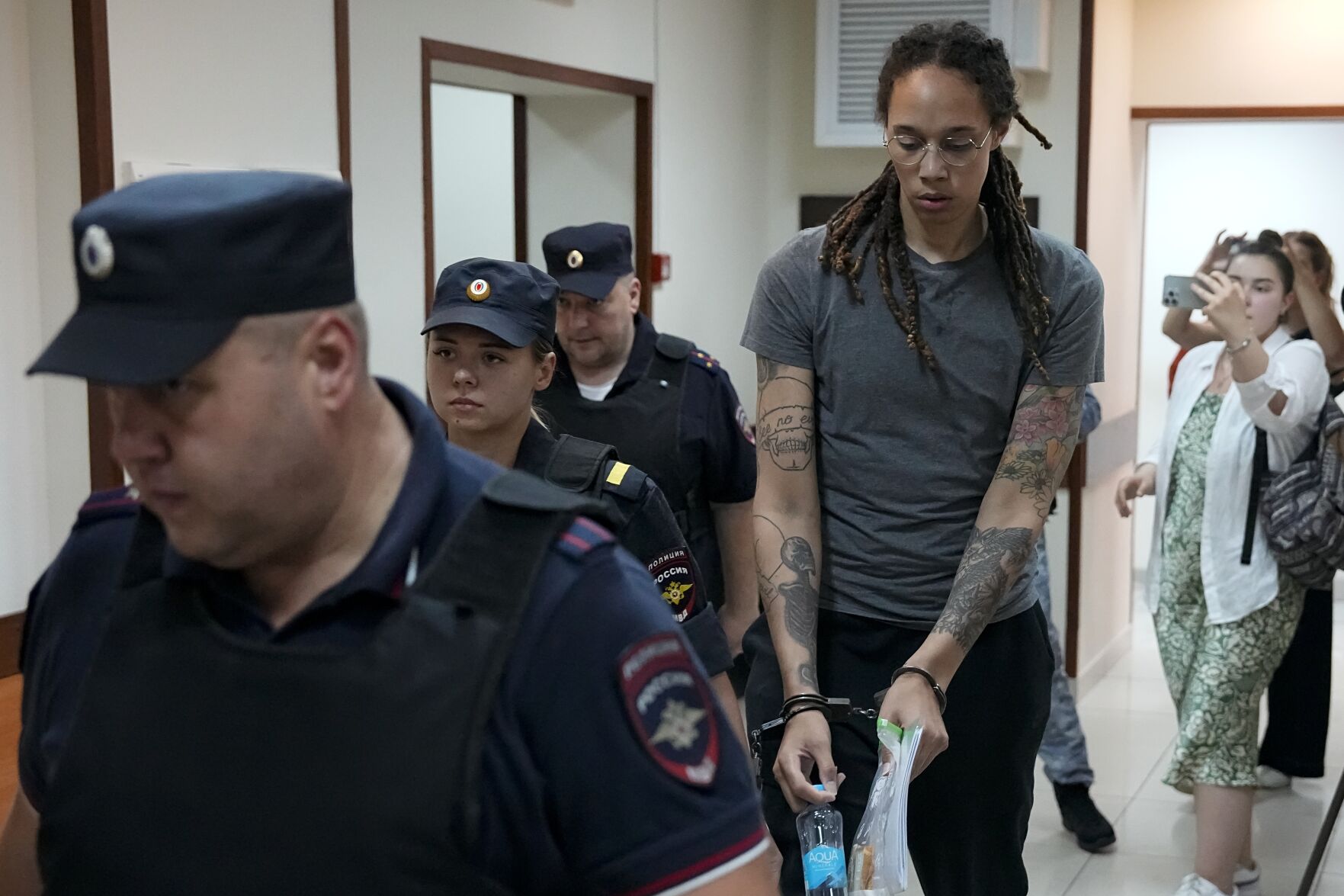 <p>WNBA star and two-time Olympic gold medalist Brittney Griner is escorted from a court room after her last words, in Khimki just outside Moscow, Russia, Thursday, Aug. 4, 2022. </p>