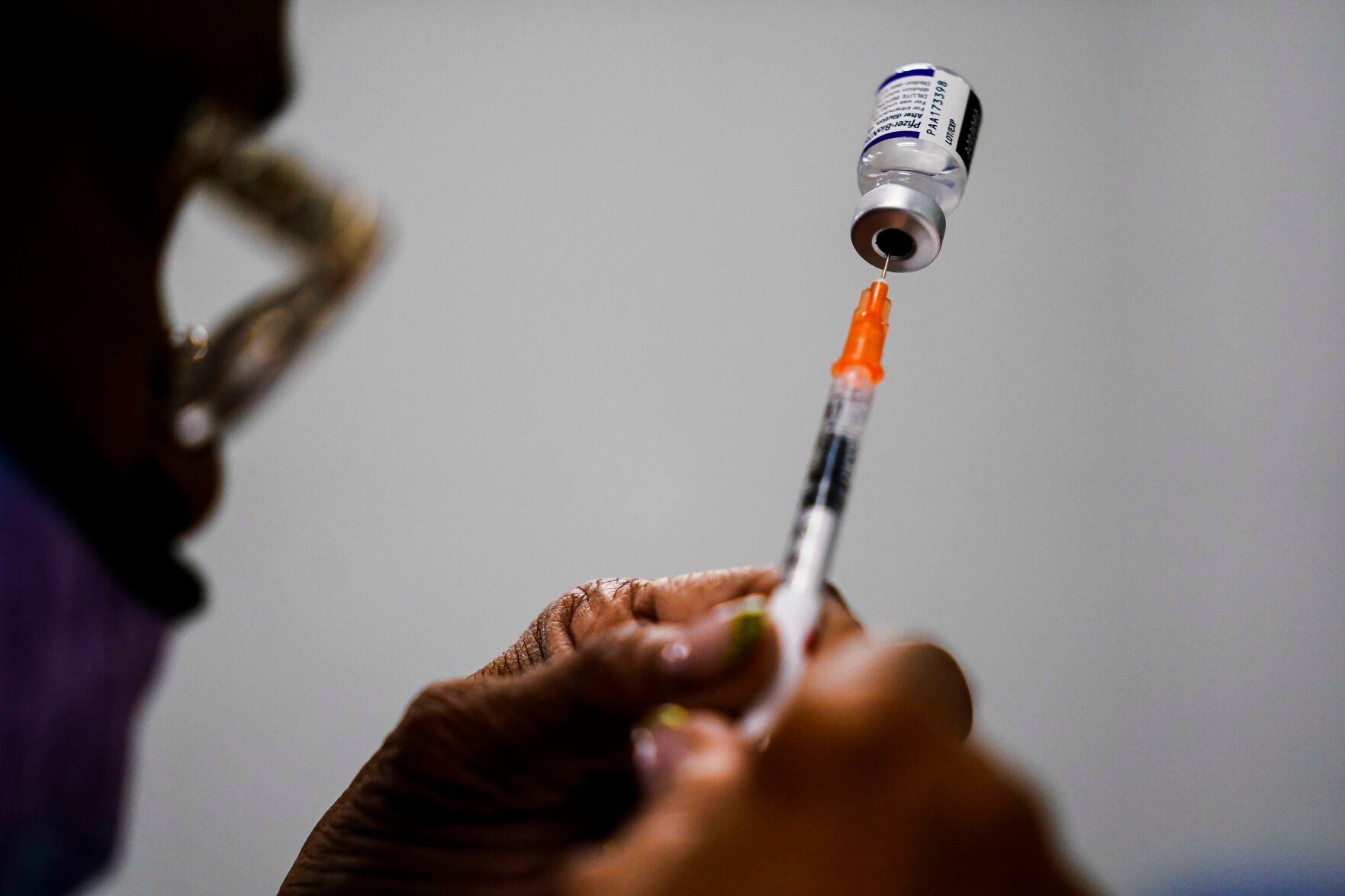 <p>FILE - A syringe is prepared with the Pfizer COVID-19 vaccine at a vaccination clinic at the Keystone First Wellness Center in Chester, Pa., Dec. 15, 2021. </p>