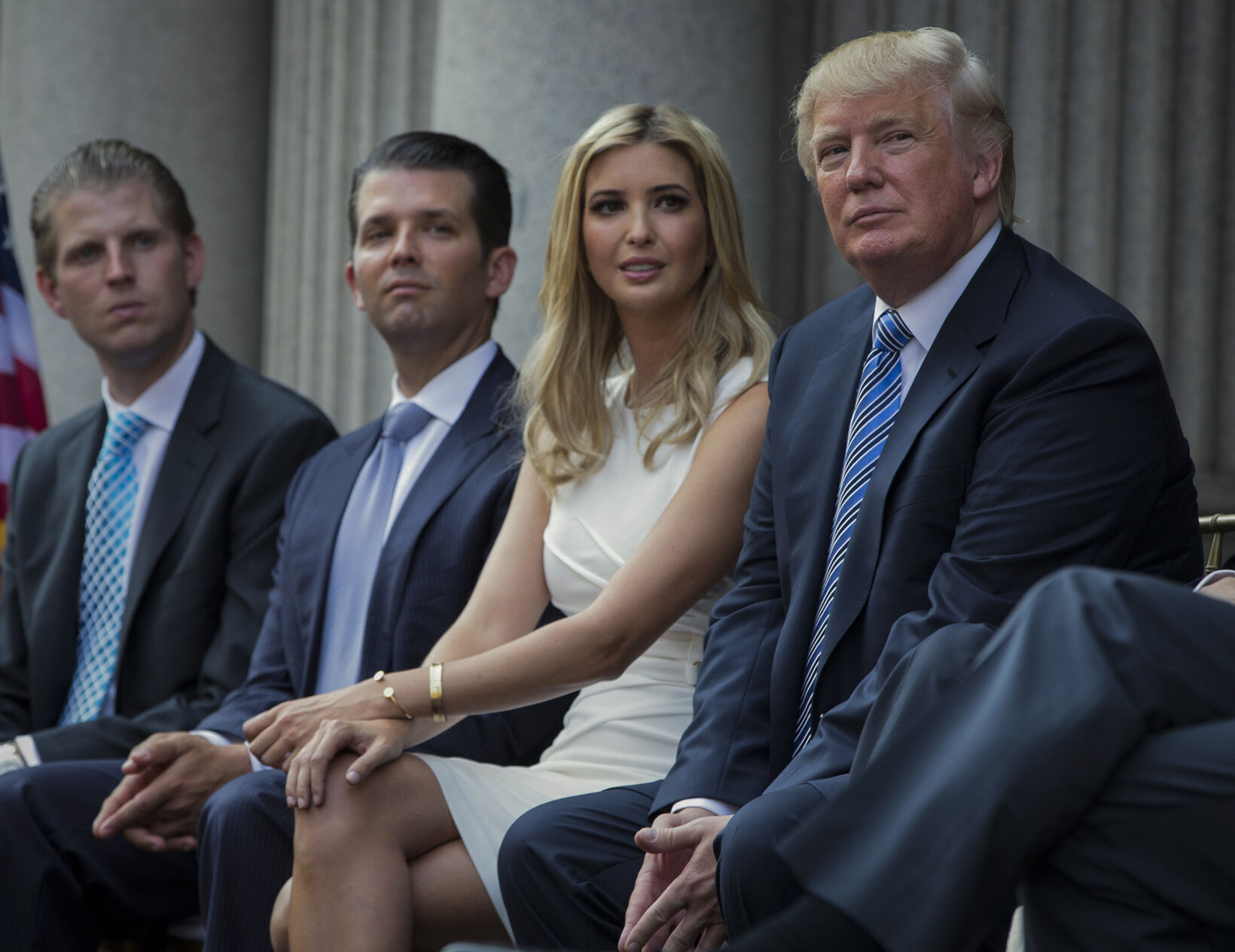<p>FILE - Donald Trump, right, sits with his children, from left, Eric Trump, Donald Trump Jr., and Ivanka Trump during a groundbreaking ceremony for the Trump International Hotel on July 23, 2014, in Washington. </p>