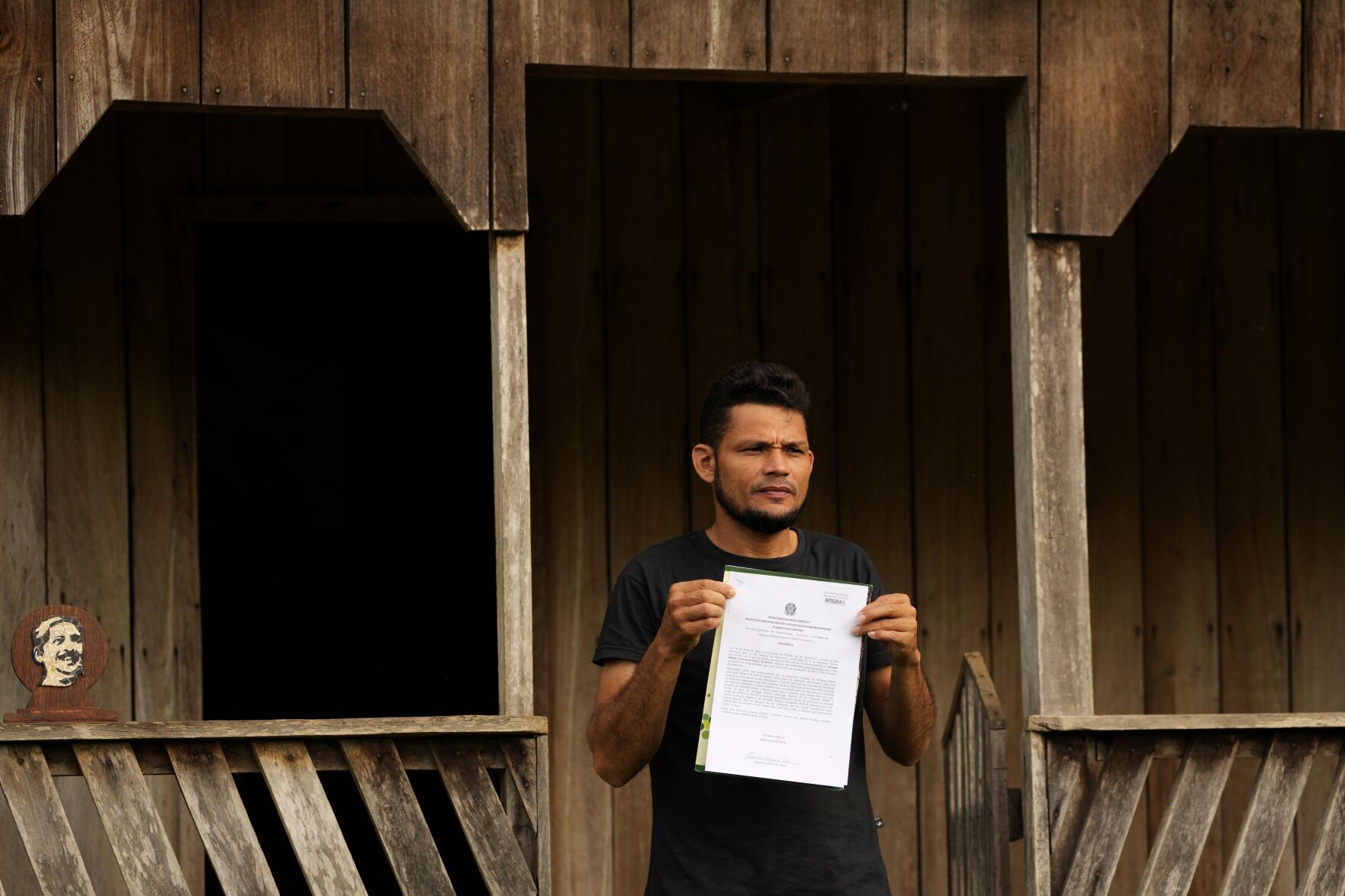 <p>Rubber-tapper Jurivan Bezerra Rios shows a document Dec. 7 denouncing the illegal sale of land in the Chico Mendes Extractive Reserve, in Xapuri, Acre state, Brazil.</p>