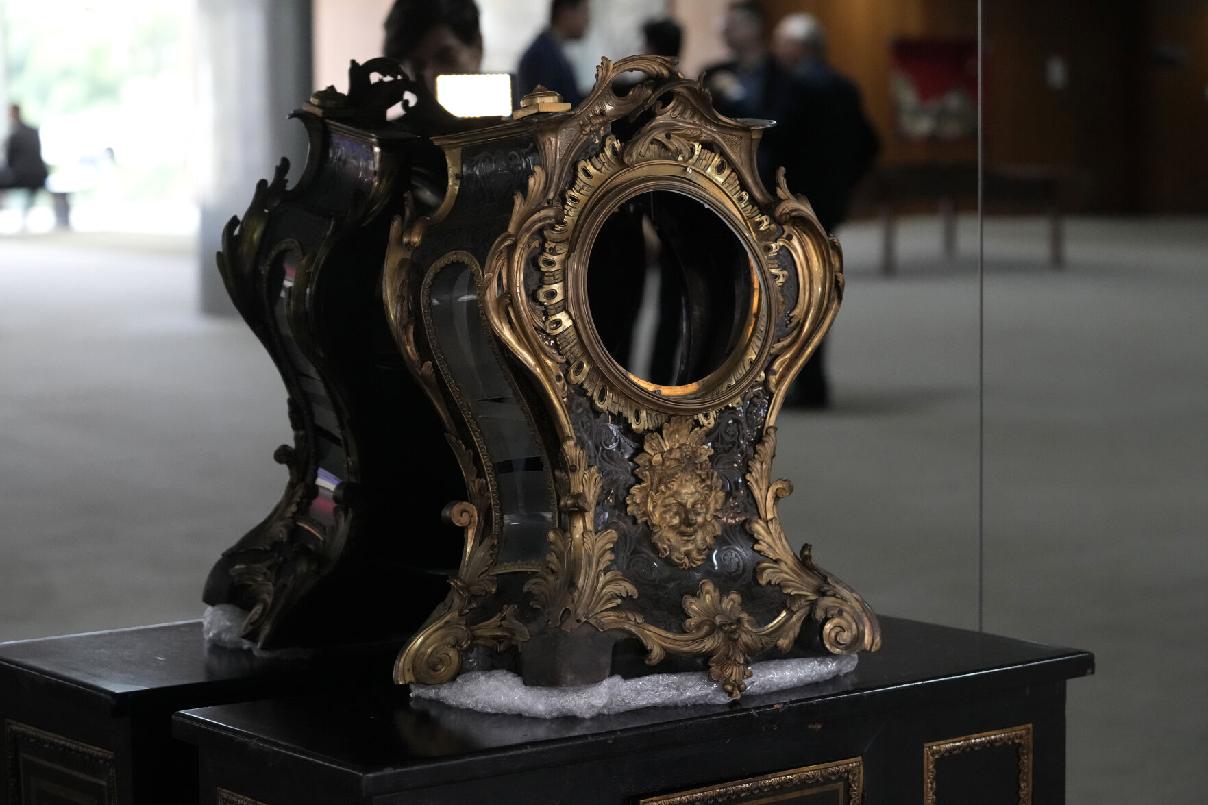 <p>A damaged 17th-century clock, gifted to Portuguese royalty by Louis XIV, stands on display Jan. 11 in the entrance hall of the presidential office at Planalto Palace after the storming of public buildings by supporters of former President Jair Bolsonaro in Brasilia, Brazil.</p>