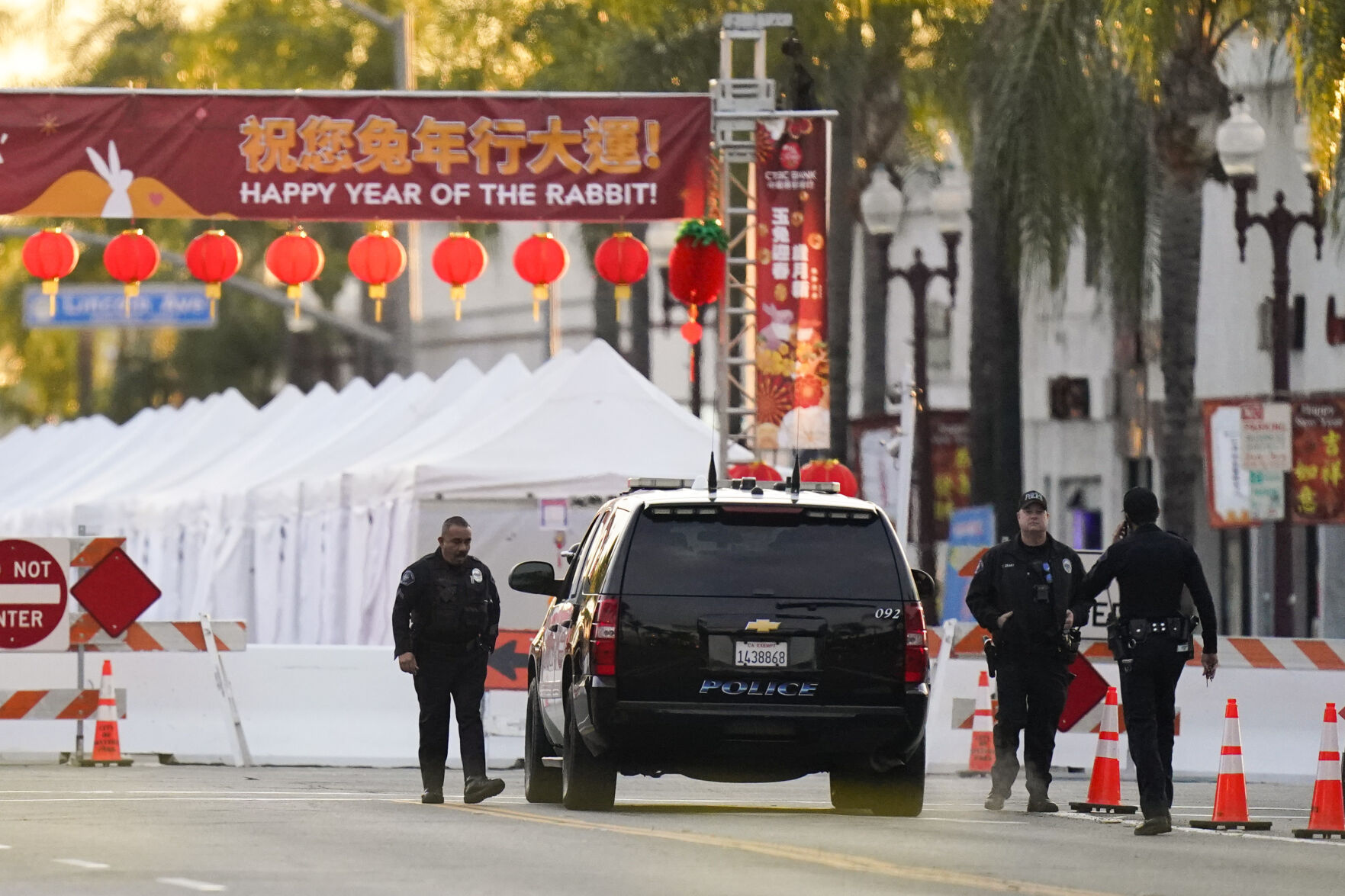 <p>Police officers stand outside a ballroom dance club Sunday in Monterey Park, Calif. A mass shooting took place at a dance club following a Lunar New Year celebration, setting off a manhunt for the suspect. </p>
