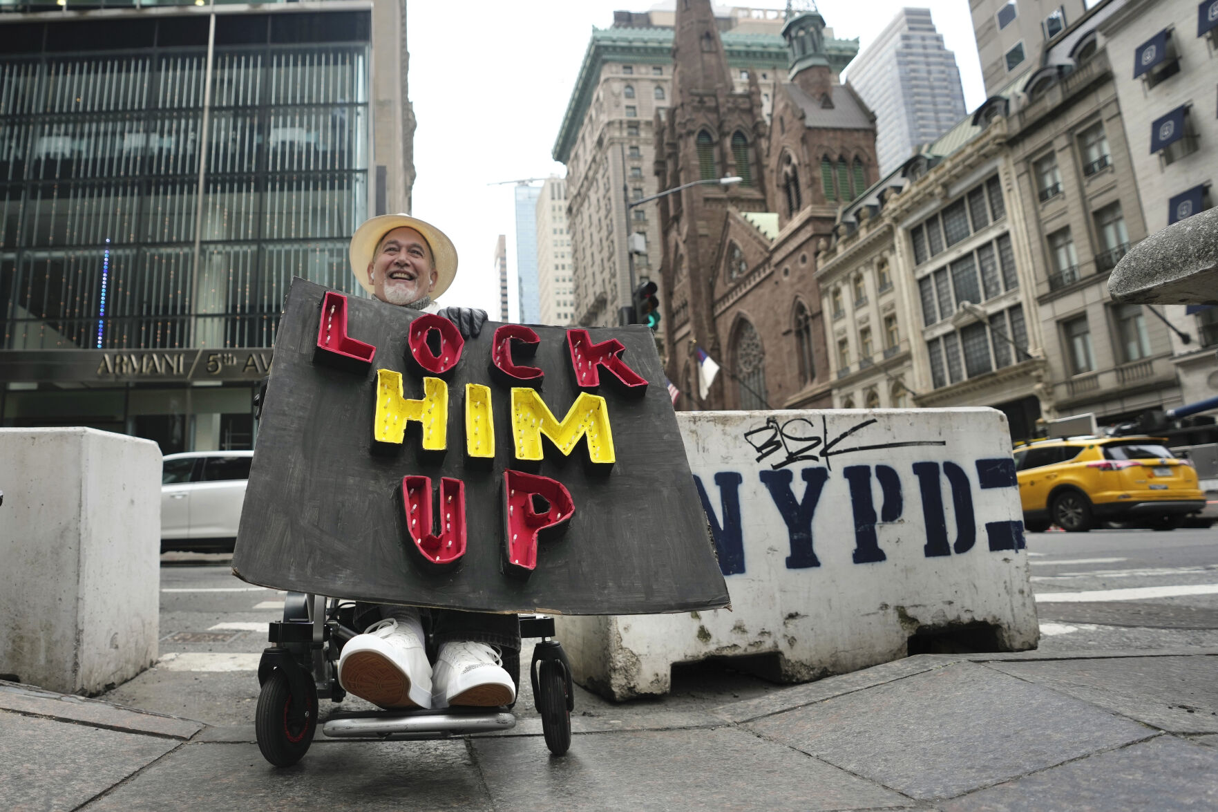 <p>Richard Fisher protests former President Donald Trump outside Trump Tower on Friday.</p>