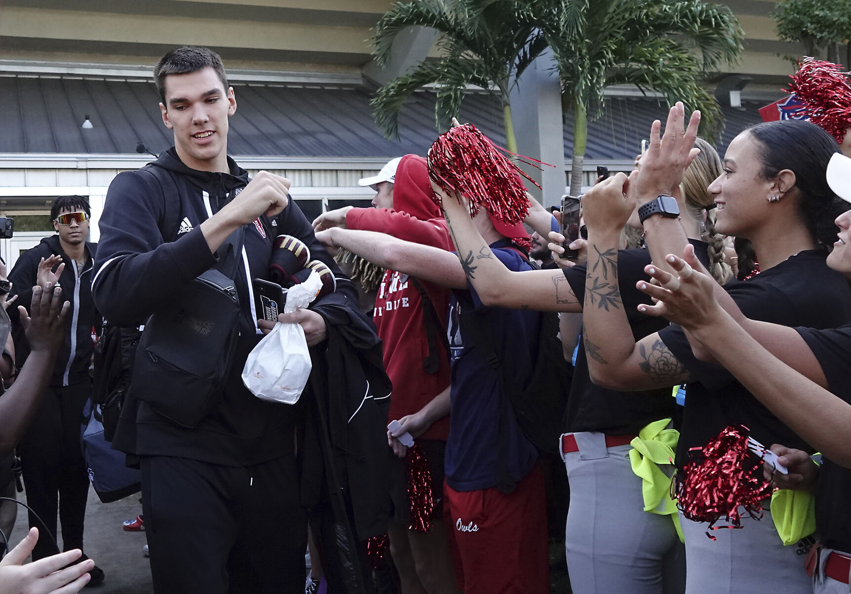 <p>Florida Atlantic University center Vladislav Goldin, of Russia, is greeted by fans Wednesday as the team leaves the campus in Boca Raton, Fla.</p>