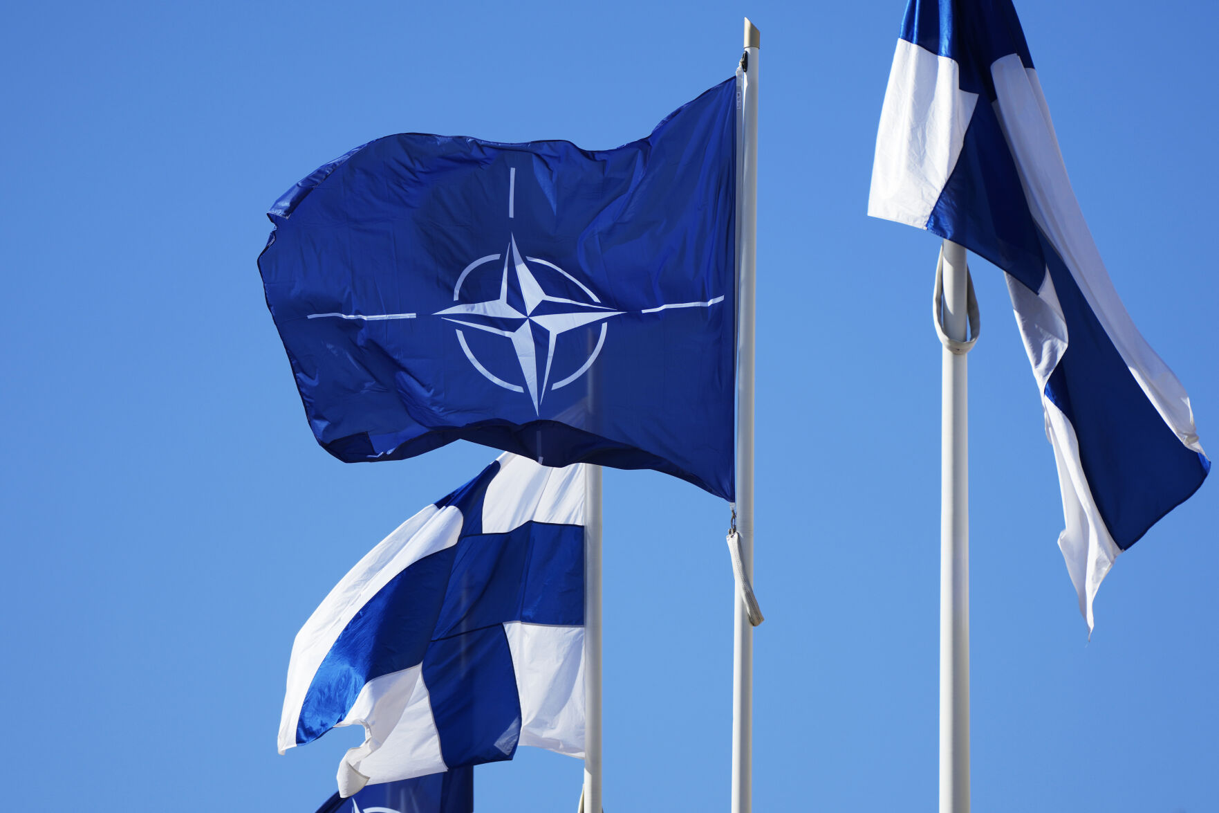 <p>NATO flag, centre, and Finland flags flutter over the building of Ministry of Foreign Affairs in Helsinki, Finland, Tuesday, April 4, 2023. </p>
