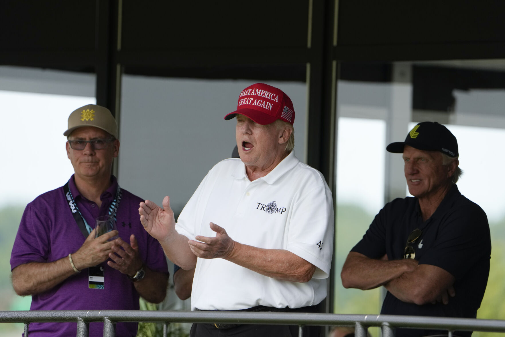 <p>Former President Donald Trump, Greg Norman, LIV Golf CEO, right, and Paul Myler, deputy head of mission for the Australian Embassy in Washington, left, watch the second round of the LIV Golf at Trump National Golf Club on May 27 in Sterling, Va. </p>
