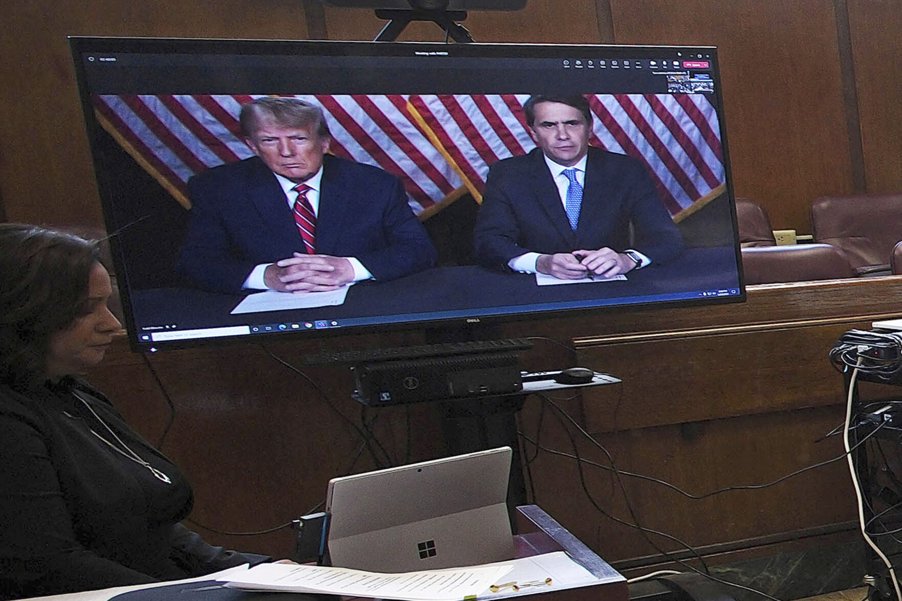 <p>Former President Donald Trump, left on screen, and his attorney, Todd Blanche, right on screen, appear by video before a hearing begins Tuesday in Manhattan criminal court.</p>