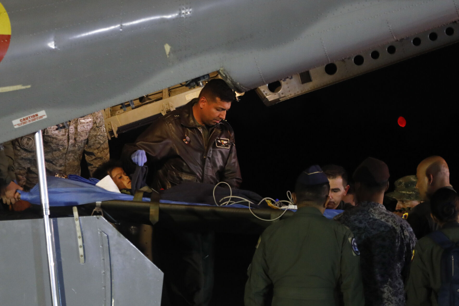 <p>Military personnel unload from a plane one of four Indigenous children who were missing after a deadly plane crash, Saturday at the military air base in Bogota, Colombia.</p>