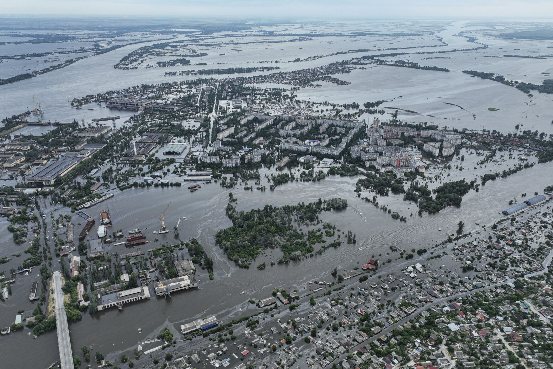 <p>Houses are seen underwater and polluted by oil in a flooded neighborhood Saturday in Kherson, Ukraine.</p>