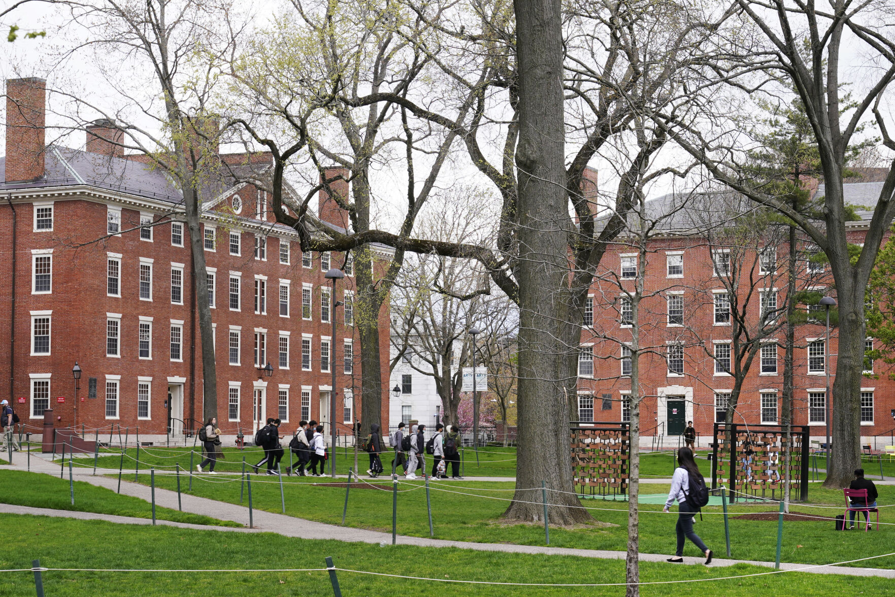 <p>FILE - Students walk through Harvard Yard, April 27, 2022, on the campus of Harvard University in Cambridge, Mass. </p>