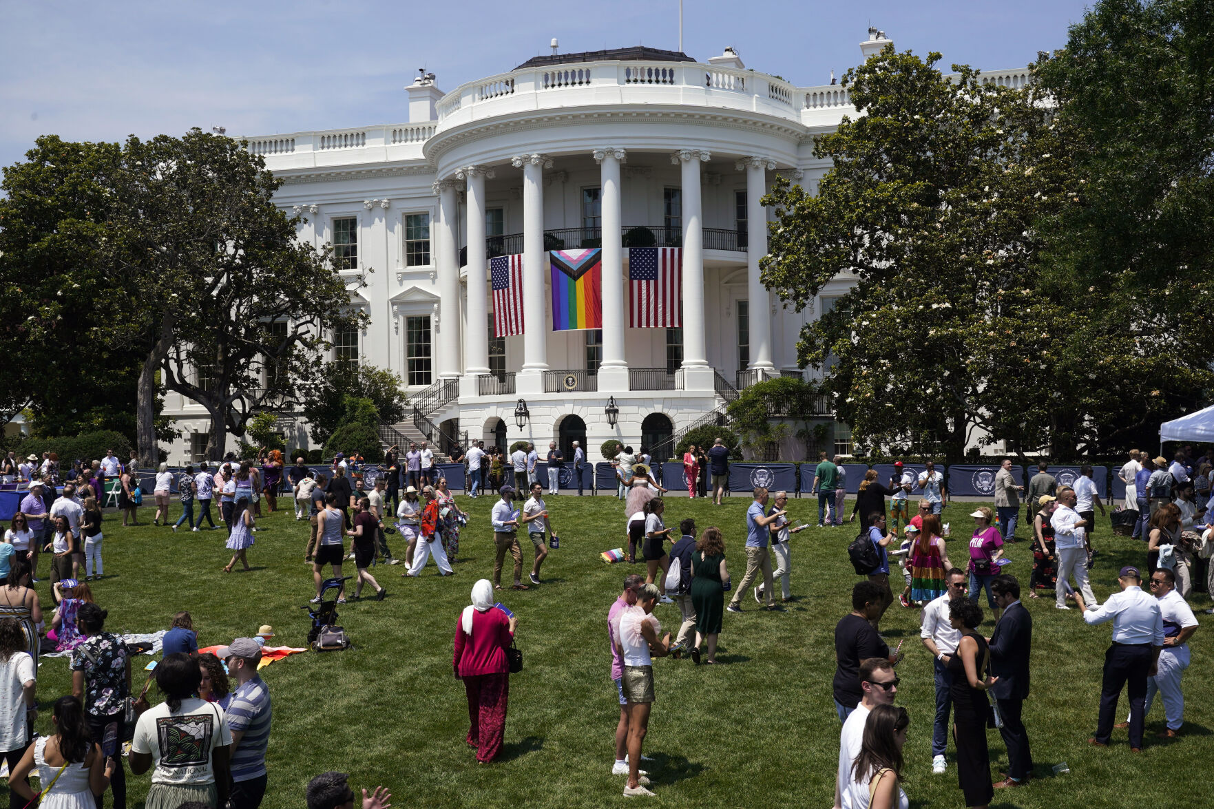 <p>People walk on the South Lawn of the White House during a Pride Month celebration Saturday in Washington. </p>