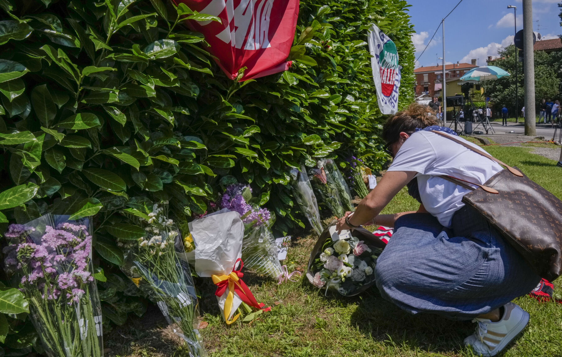 <p>People bring flowers outside Silvio Berlusconi's residence Monday in Arcore, near Milan.</p>