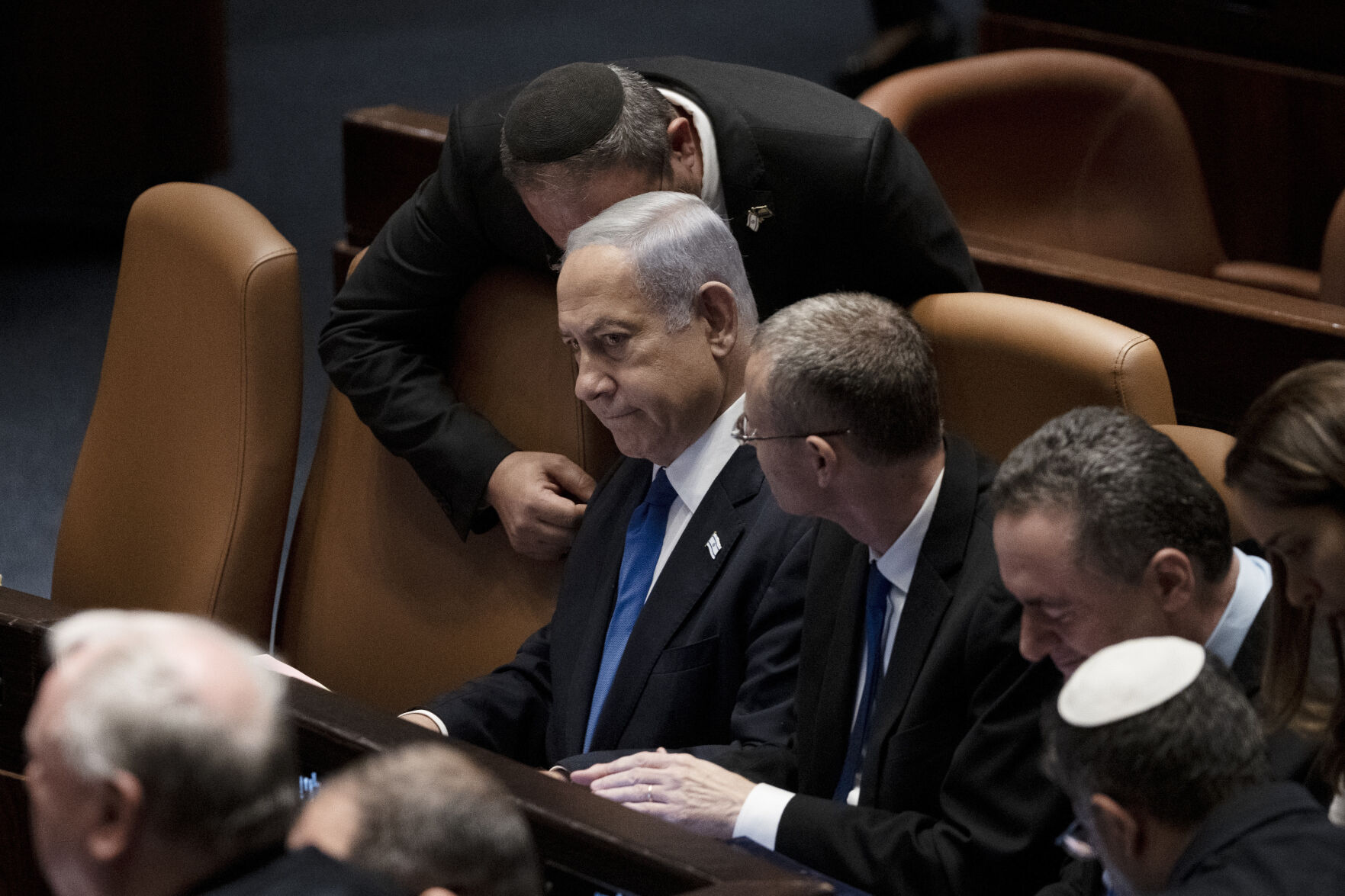 <p>Israel's Prime Minister Benjamin Netanyahu, center, is surrounded by lawmakers at a session of the Knesset, Israel's parliament, in Jerusalem, Israel, Monday, July 24, 2023. </p>