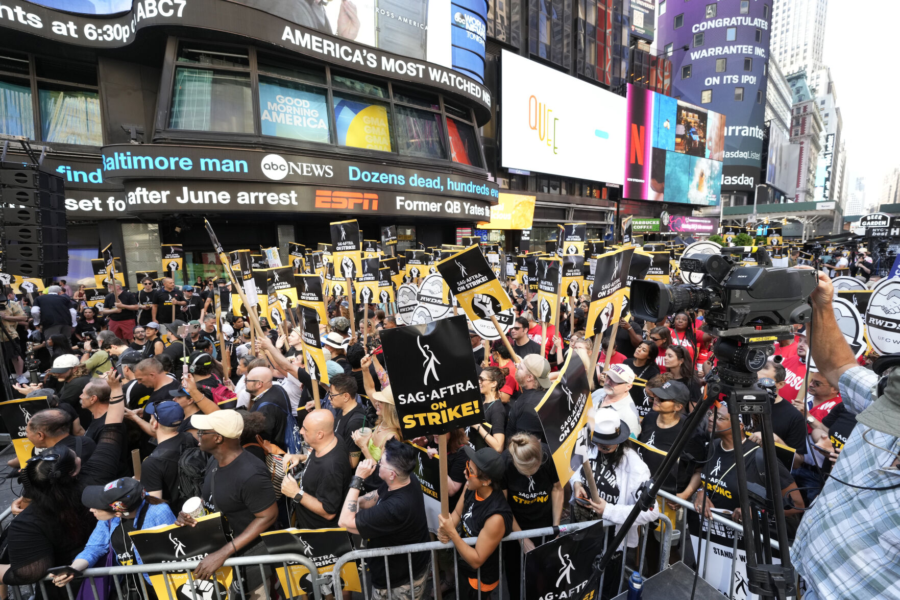 <p>People holding picket signage attend the SAG-AFTRA "Rock the City for a Fair Contract" rally in Times Square on Tuesday, July 25, 2023, in New York. The actors strike comes more than two months after screenwriters began striking in their bid to get better pay and working conditions. (Photo by Charles Sykes/Invision/AP)</p>