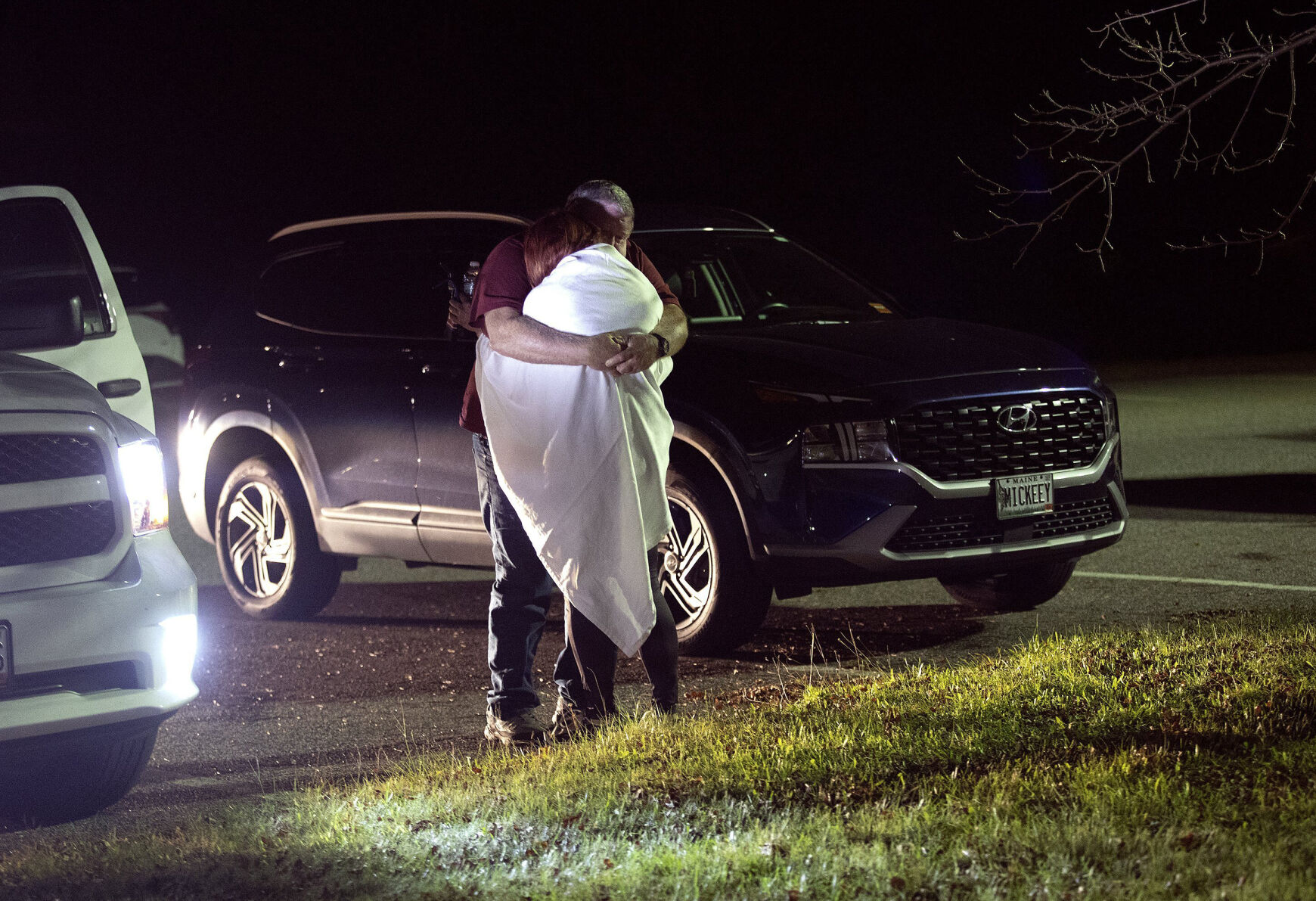 <p>A woman is hugged by a man late Wednesday at a reunification center at Auburn Middle School, in Auburn, Maine, after shootings in Lewiston.</p>