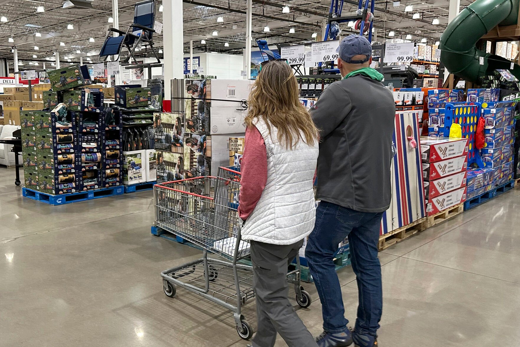 <p>Shoppers pass displays of goods in a Costco warehouse Feb. 25, 2024, in Sheridan, Colo. </p>