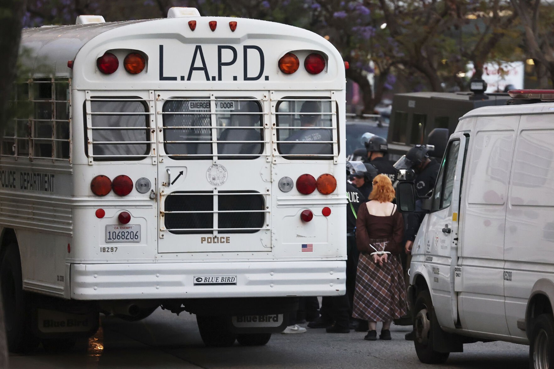 <p>Protesters are loaded onto Los Angeles Police Department buses Wednesday in Los Angeles. </p>