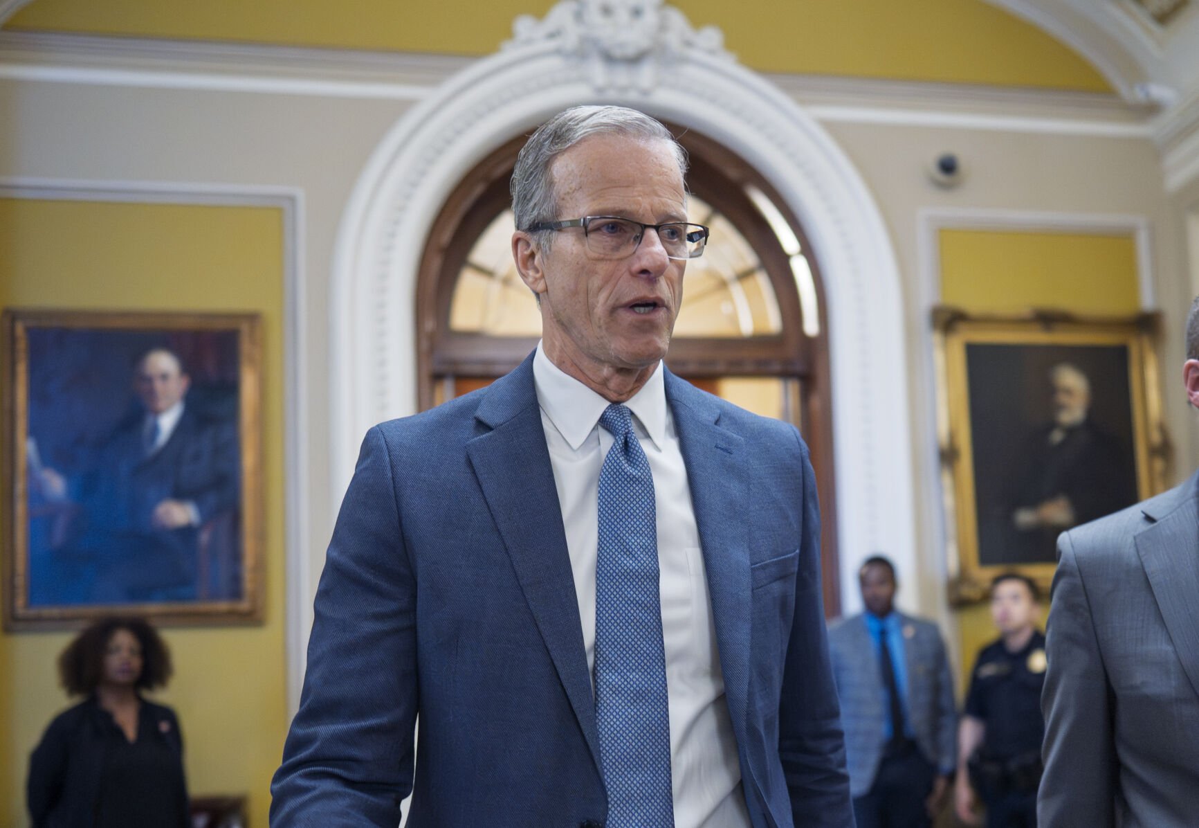 <p>Senate Majority Leader John Thune, R-S.D., rushes from the chamber to his office as he struggles with Republicans opposed to President Donald Trump's signature bill of big tax breaks and spending cuts, at the Capitol in Washington, July 1.</p>