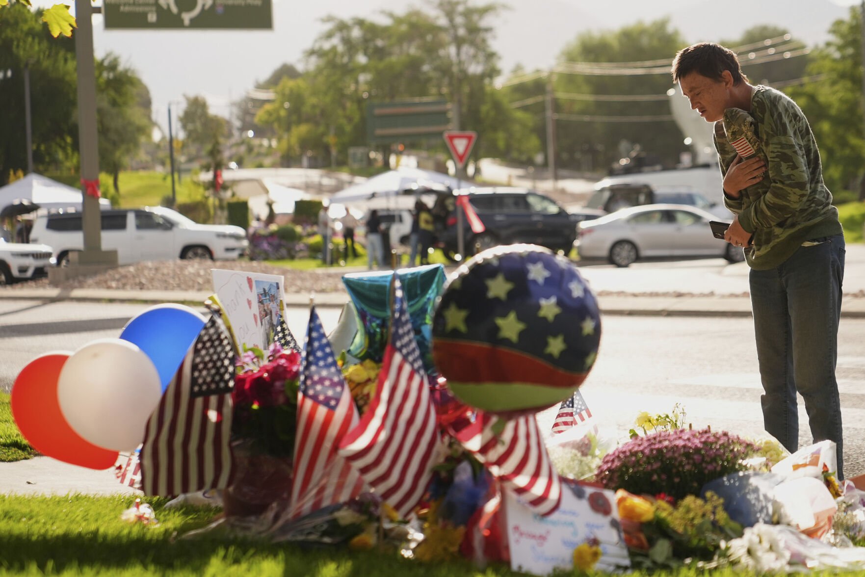 <p>Wendy Lucas, a Utah Valley University student, looks at a memorial set up for Charlie Kirk on Friday at Utah Valley University in Orem, Utah. </p>