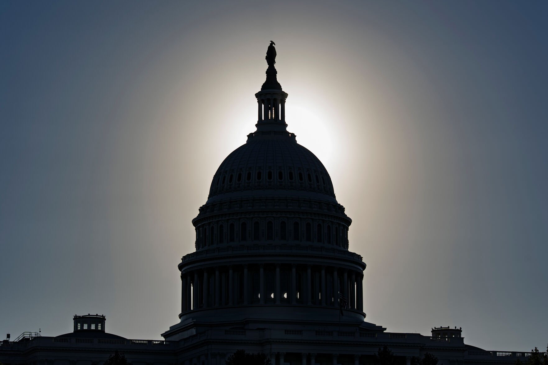 <p>The U.S. Capitol is silhouetted by the stark glare of the morning sun as a government shutdown begins its tenth day, in Washington, Oct. 10.</p>
