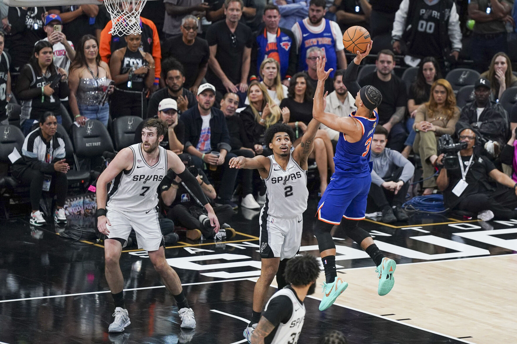 <p>New York Knicks guard Josh Hart shoots the ball over San Antonio Spurs guard Dylan Harper during Game 5 of the NBA Finals on Saturday at Frost Bank Center in San Antonio.</p>