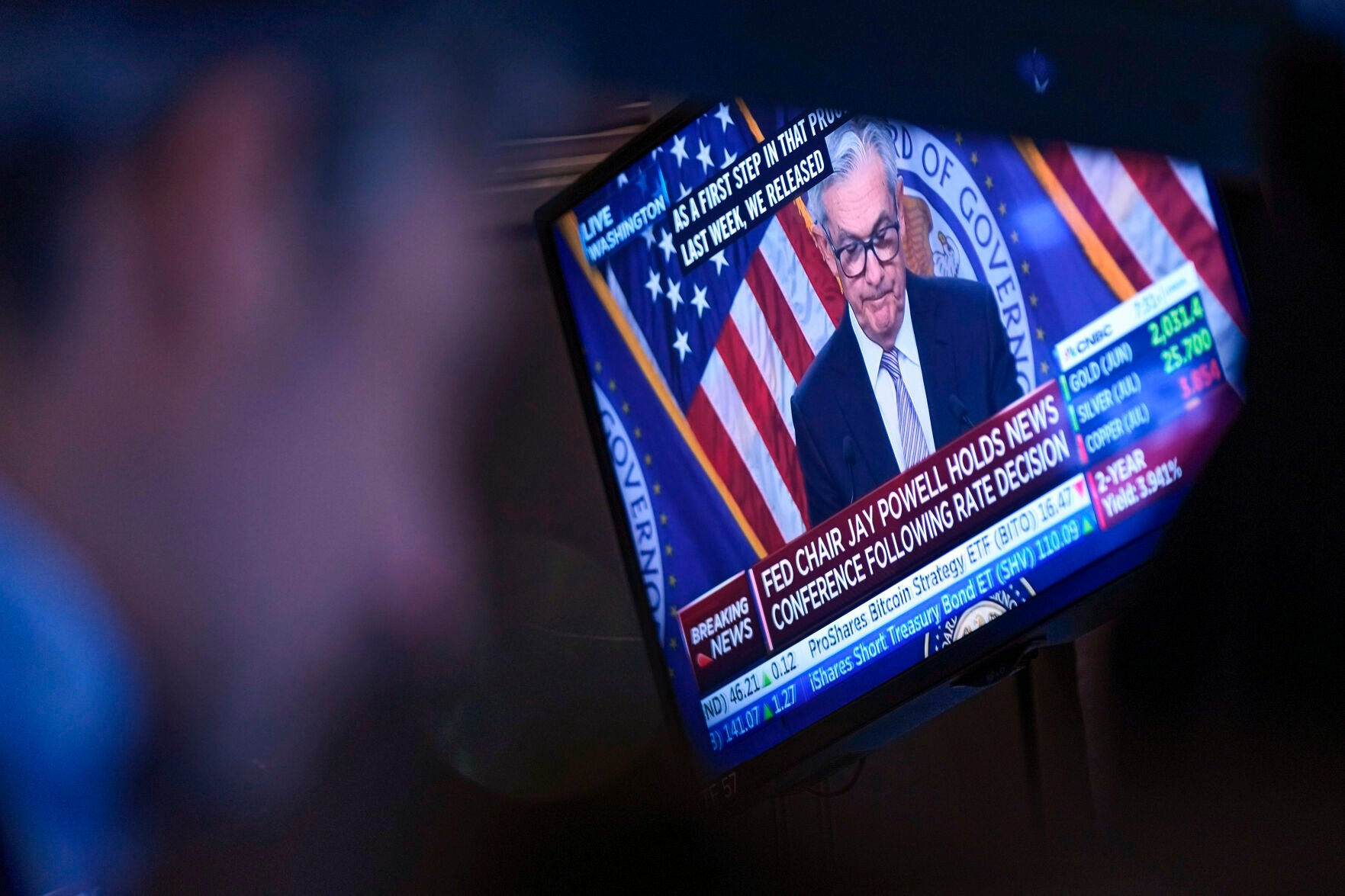 <p>File - A news conference by Federal Reserve Chairman Jerome Powell is displayed on the floor at the New York Stock Exchange in New York, Wednesday, May 3, 2023. The Federal Reserve wraps up its two-day policy meeting Wednesday. Many analysts expect that the central bank will pause raising its benchmark borrowing rate for the first time in 15 months. (AP Photo/Seth Wenig, File)</p>