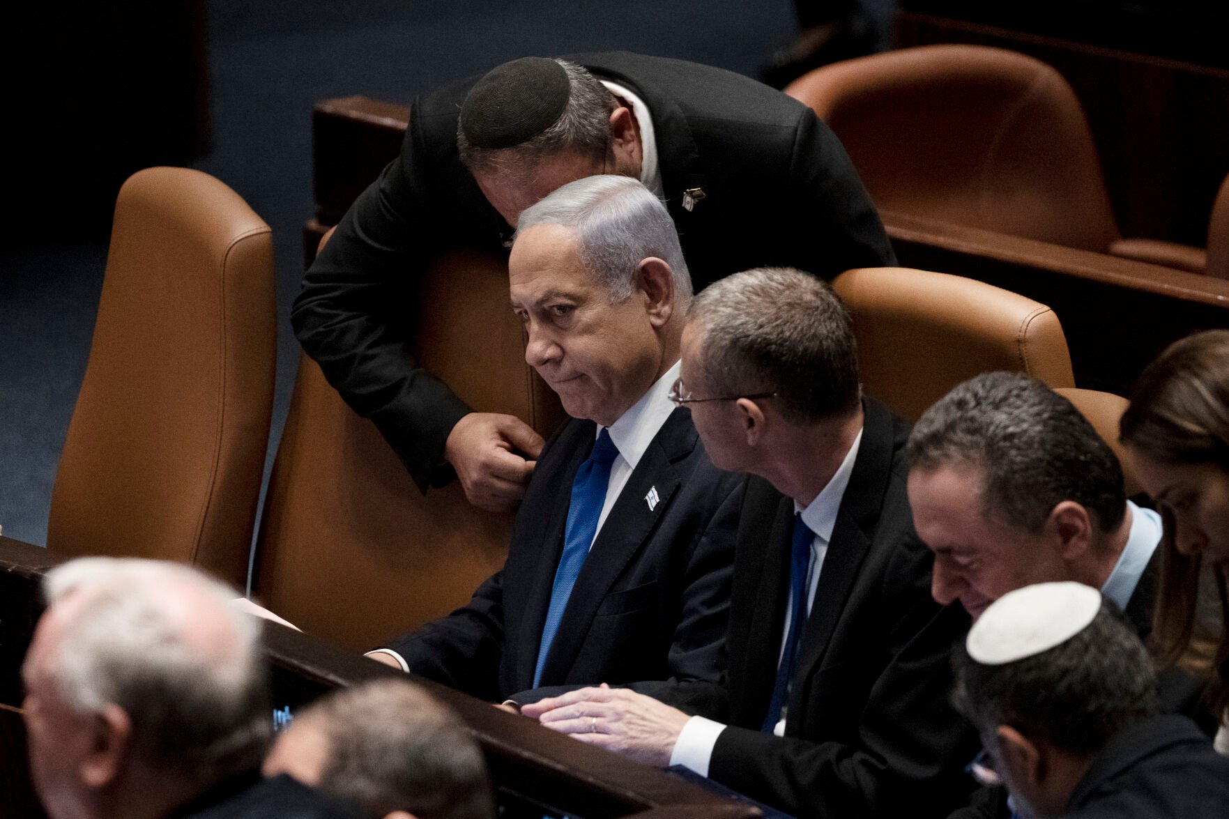 <p>Israel's Prime Minister Benjamin Netanyahu, center, is surrounded by lawmakers at a session of the Knesset, Israel's parliament, in Jerusalem, Israel, Monday, July 24, 2023. </p>