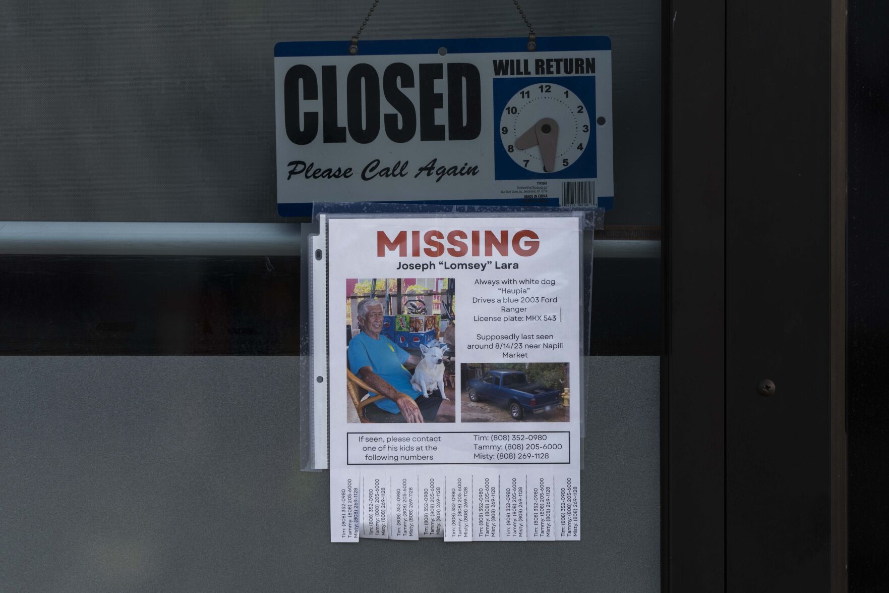 <p>A missing person flyer for Joseph "Lomsey" Lara is posted on the door of a business in a shopping mall in Lahaina, Hawaii, Monday, Aug. 21, 2023. Wildfires devastated parts of the Hawaiian island of Maui earlier this month.</p>