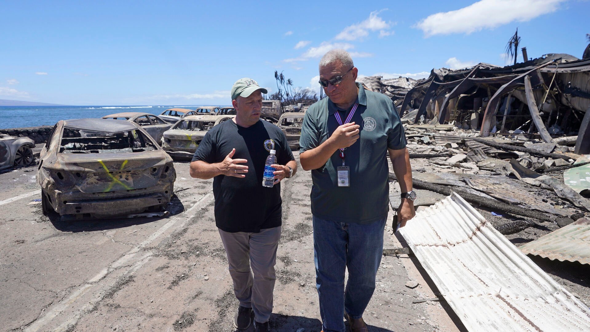 <p>Hawaii Gov. Josh Green, left, and Maui County Mayor Richard Bissen, Jr., speak during a tour of wildfire damage Saturday in Lahaina, Hawaii.</p>