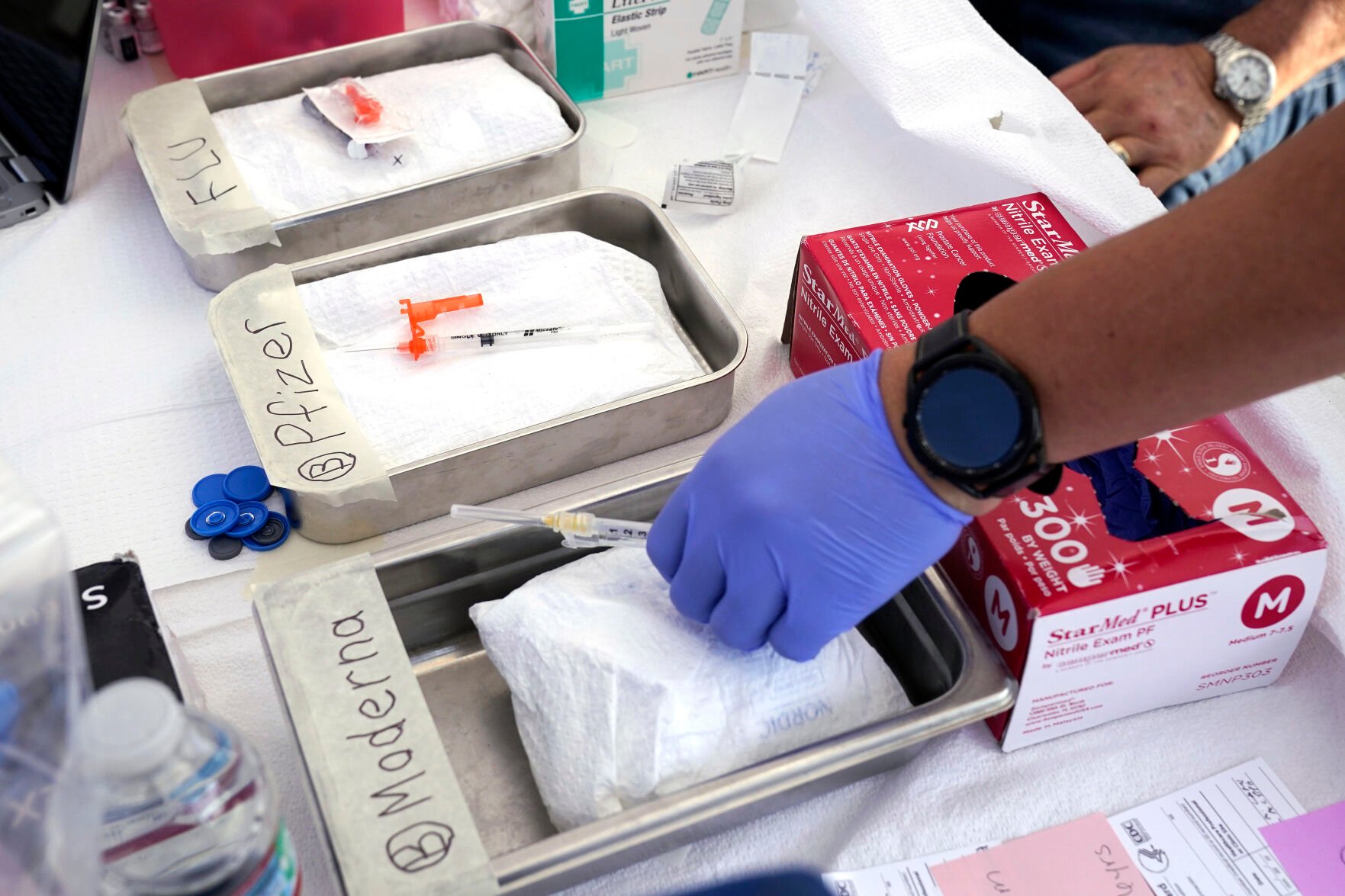 <p>FILE - Syringes with vaccines are prepared at the L.A. Care and Blue Shield of California Promise Health Plans' Community Resource Center where they were offering members and the public free flu and COVID-19 vaccines Oct. 28, 2022, in Lynwood, Calif. </p>
