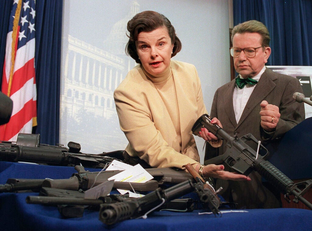 <p>FILE - Sen. Dianne Feinstein, D-Calif., left, accompanied by Sen. Paul Simon, D-Ill., holds an AR-15 assault-style rifle with a collapsible stock during a Capitol Hill news conference Friday March 22, 1996, after the House voted to repeal the two-year-old assault-style firearms ban. </p>