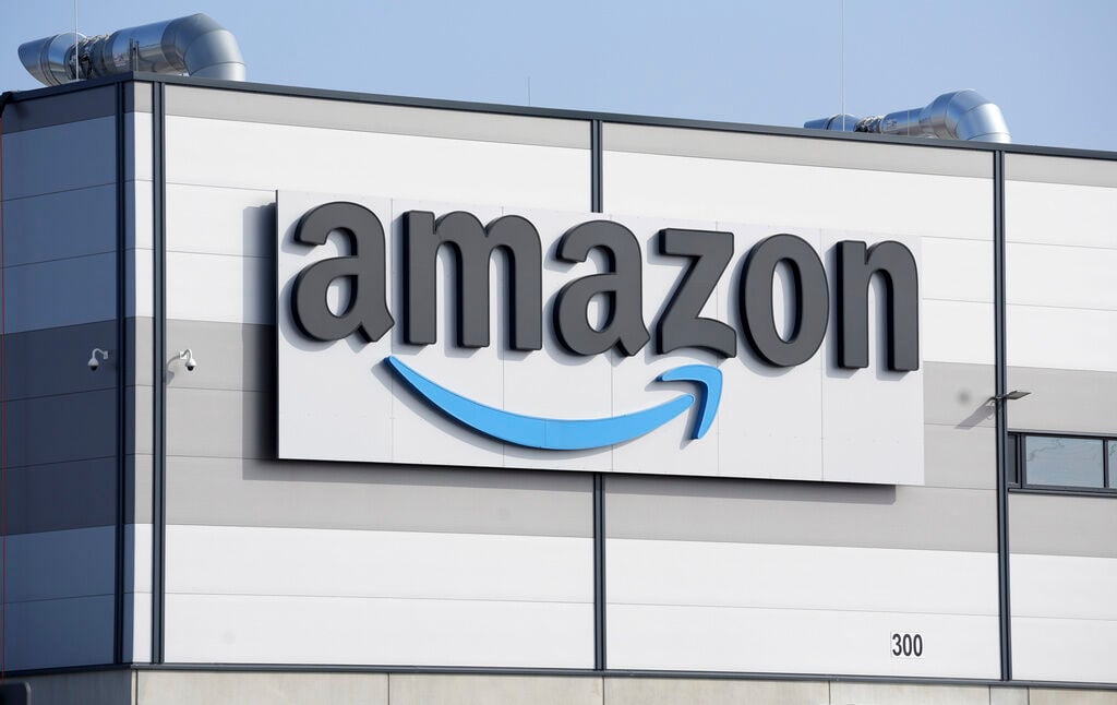 <p>FILE - An Amazon company logo marks the facade of a building in Schoenefeld near Berlin, March 18, 2022. </p>