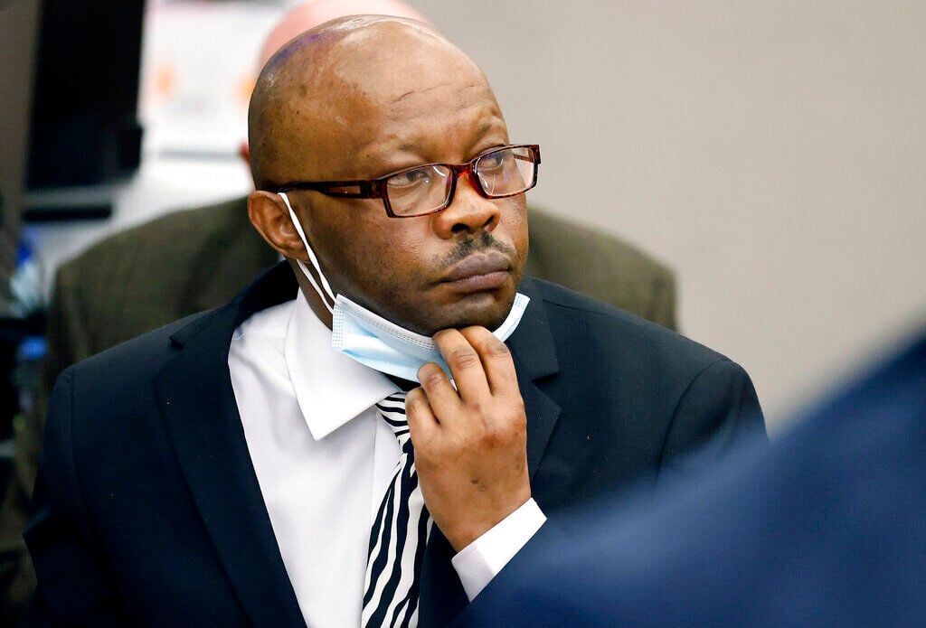 <p>FILE - Defendant Billy Chemirmir lowers his mask as a state witness is asked to identify him during his murder trial at the Frank Crowley Courts Building in Dallas, Nov. 17, 2021. </p>