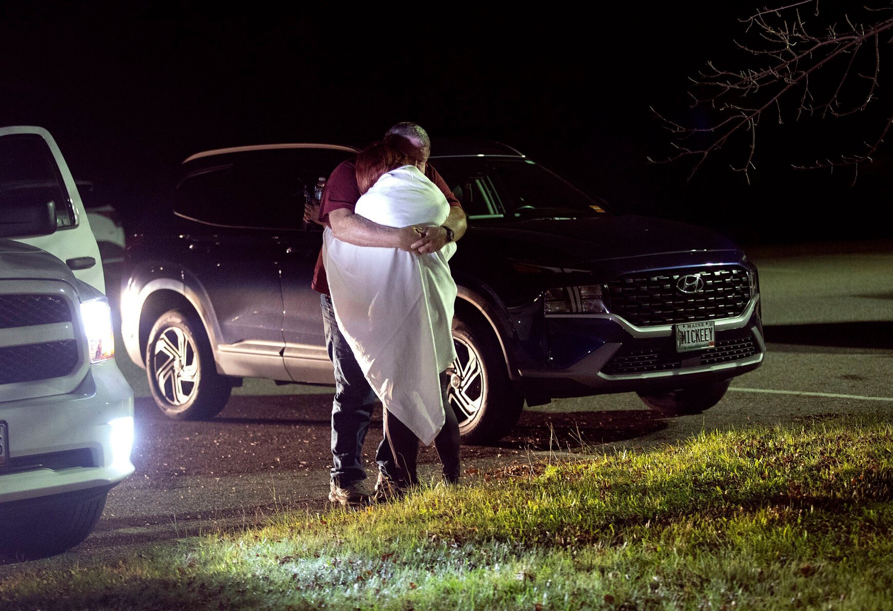 <p>A woman is hugged by a man late Wednesday at a reunification center at Auburn Middle School, in Auburn, Maine, after shootings in Lewiston.</p>