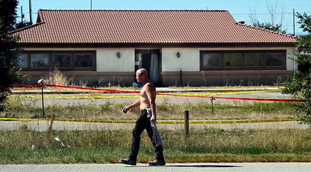 <p>James Glidewell walks past the Return To Nature Funeral Home in Penrose, Colo. Thursday, Oct. 5, 2023. </p>
