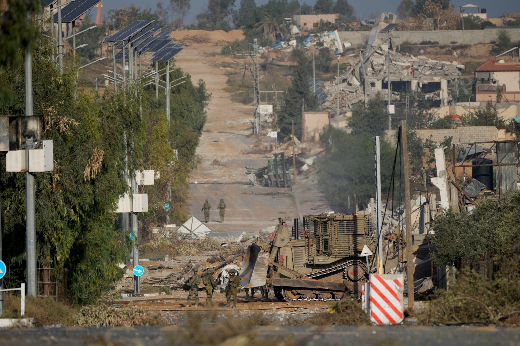 <p>Israeli soldiers stand on Salah al-Din road in central Gaza Strip on Friday, Nov. 24, 2023, as the temporary ceasefire went into effect. (AP Photo/Hatem Moussa)</p>