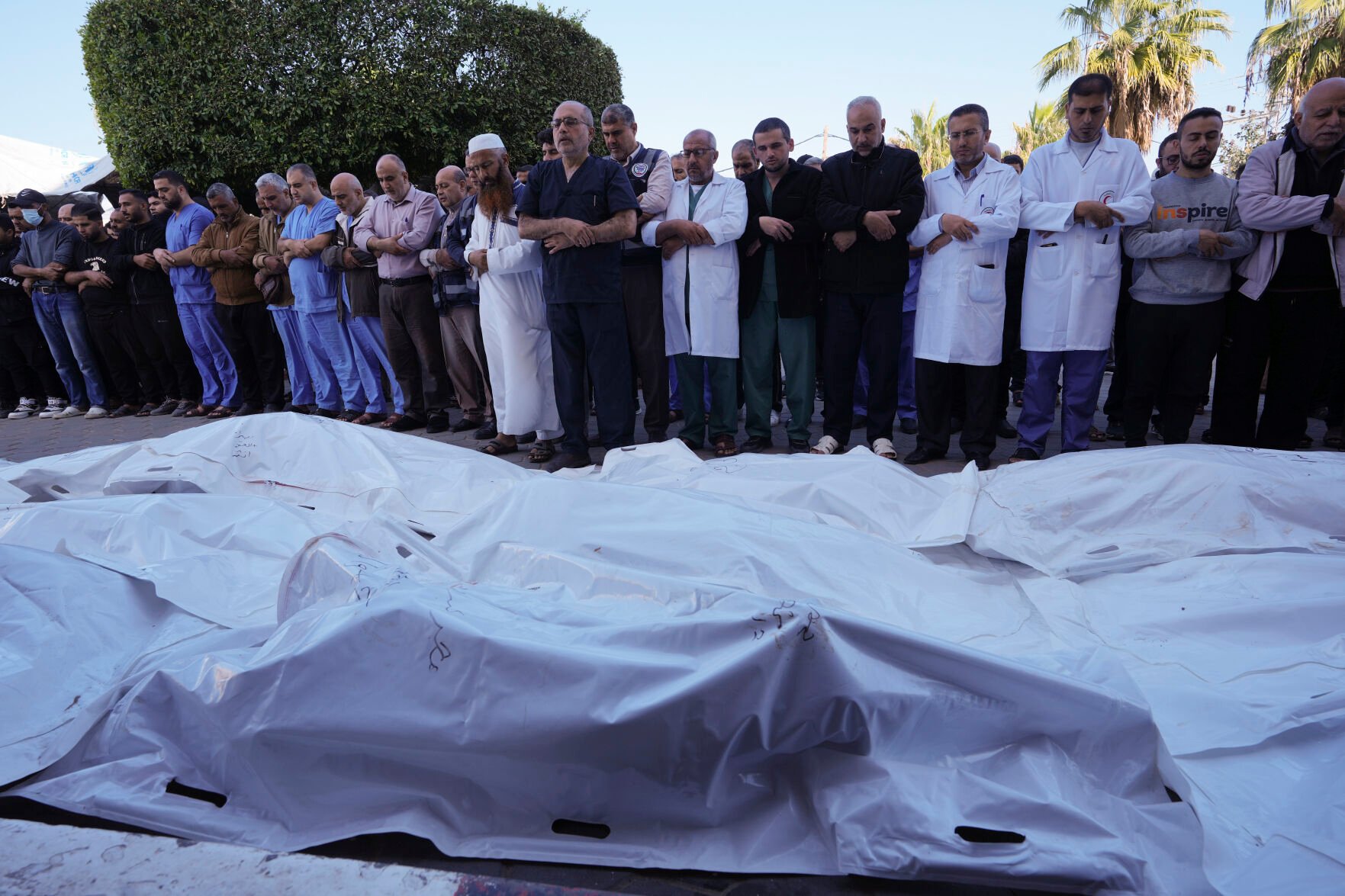 <p>Palestinians pray Tuesday for their relatives killed in the Israeli bombardment of the Gaza Strip in front of the morgue of al Aqsa Hospital in Deir al Balah, Gaza Strip.</p>