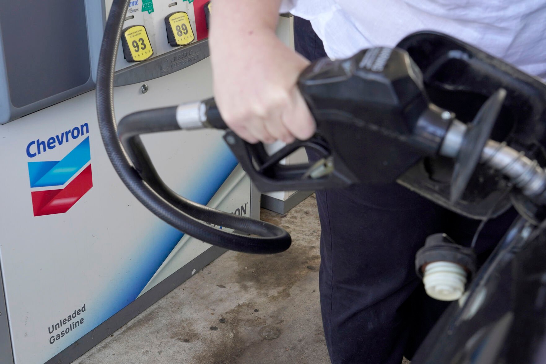 <p>A customer pumps gas at a Chevron station in Columbus, Miss., Monday, Oct. 23, 2023. (AP Photo/Rogelio V. Solis)</p>