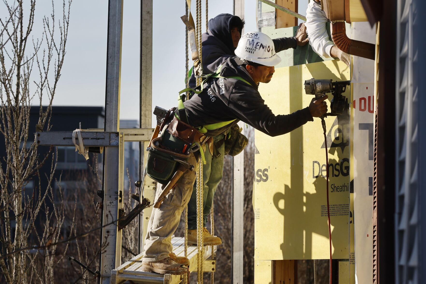 <p>Workers apply sheathing to the exterior of a new multifamily residential building, Friday, Nov. 3, 2023, in the East Boston neighborhood of Boston. On Friday, the U.S. government issues its November jobs report. (AP Photo/Michael Dwyer)</p>