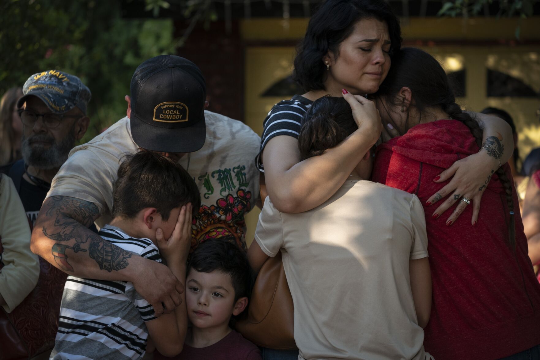 <p>Raquel Martinez comforts her two daughters May 26, 2022, while her husband, Daniel Martinez, comforts their sons outside Robb Elementary School in Uvalde, Texas. Police officials who responded to the deadly school shooting waited far too long to confront the gunman, acted with “no urgency” in establishing a command post and communicated inaccurate information to grieving families, according to a Justice Department report released Thursday.</p>