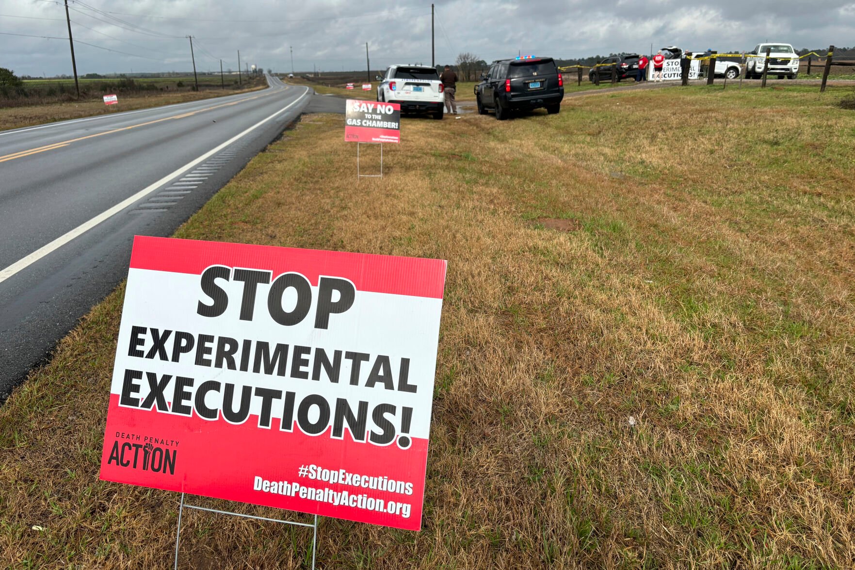 <p>Anti-death penalty activists place signs along the road heading to Holman Correctional Facility in Atmore, Ala., ahead of the scheduled execution of Kenneth Eugene Smith on Thursday.</p>