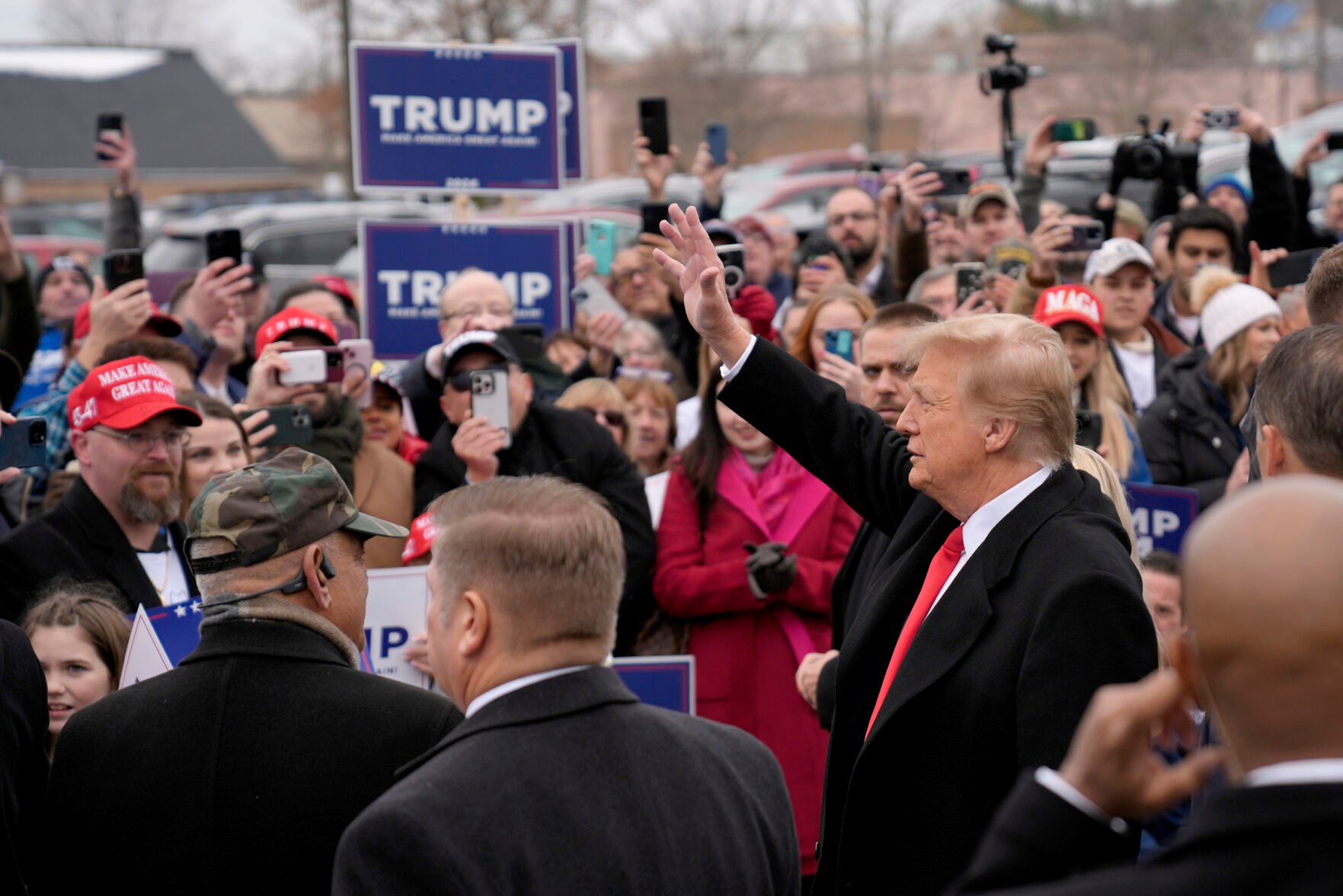 <p>Republican presidential candidate and former President Donald Trump waves to supporters as he arrives Tuesday at a campaign stop in Londonderry, N.H.</p>