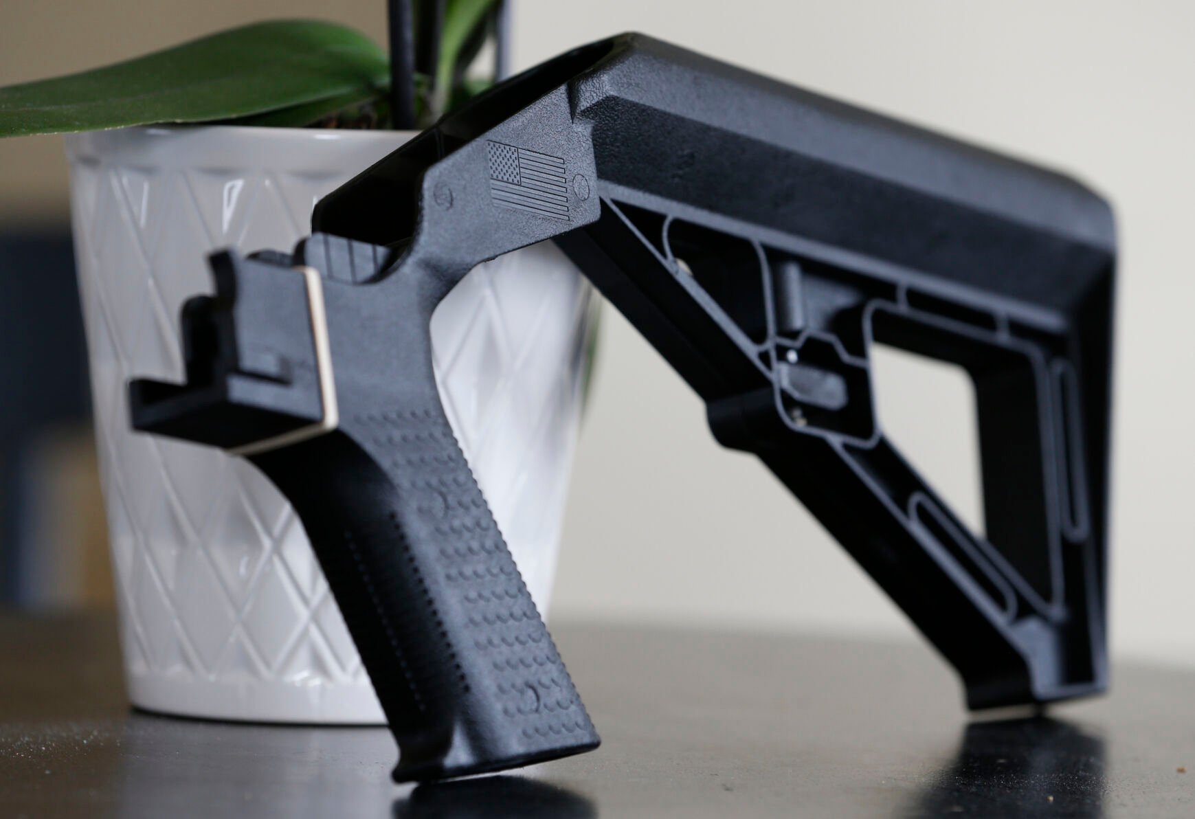 <p>FILE - In this March 15, 2019, file photo, a bump stock is displayed in Harrisonburg, Va. The Supreme Court has agreed to decide whether a ban on gun attachments that allow semi-automatic weapons to fire rapidly like machine guns violates federal law. The justices said Friday they'll hear arguments next year over a gun bump stocks regulation the Justice Department implemented after the 2017 Las Vegas mass shooting. (AP Photo/Steve Helber, File)</p>