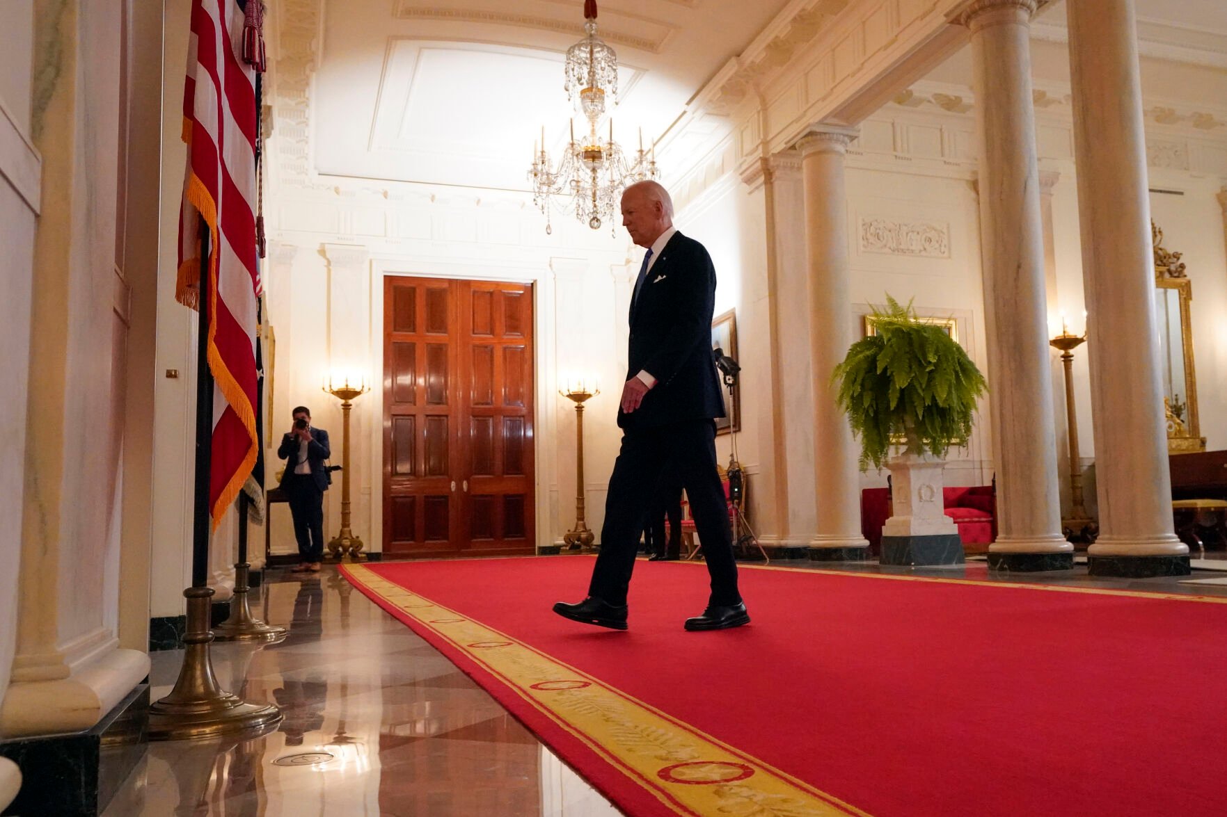 <p>President Joe Biden walks from the podium after speaking Monday in the Cross Hall of the White House.</p>