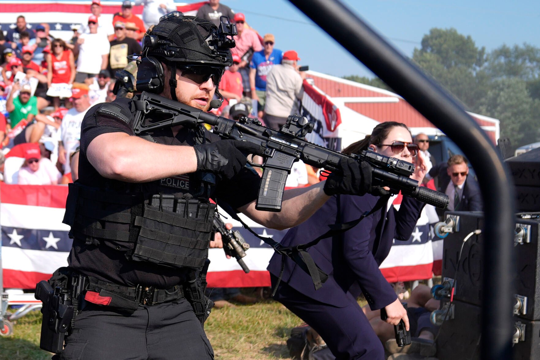 <p>U.S. Secret Service agents surround the stage Saturday as other agents cover Republican presidential candidate former President Donald Trump at a campaign rally in Butler, Pa.</p>